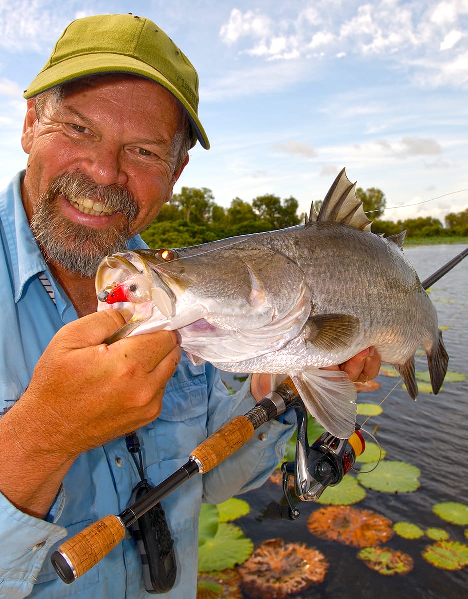 Starlo with a nice barramundi, pulled from amongst the lilies at Corroboree Billabong.